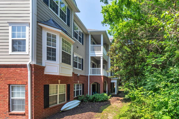 View of a multi-story building with brick and siding exterior and balconies.