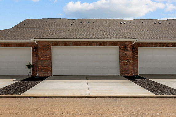 Front view of a brick house with a double garage.