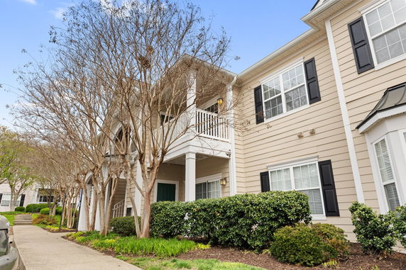 Front view of a two-story residential building with a balcony.