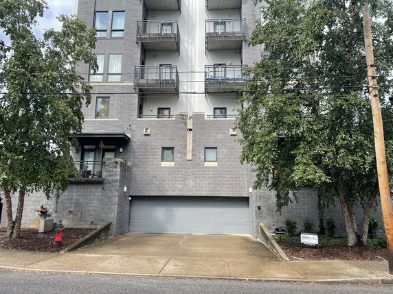 Front view of a multi-story building with balconies.