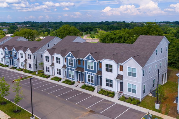 Front view of a row of townhouses with modern design and two stories.