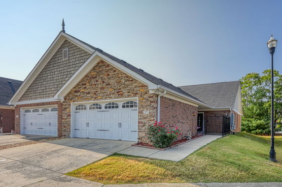 Front view of a house with a double garage and brick exterior.