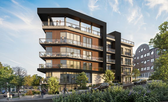 Front view of a modern multi-story apartment building with large glass windows and balconies.