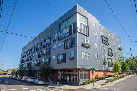 Front view of a multi-story residential or commercial building on a corner street.