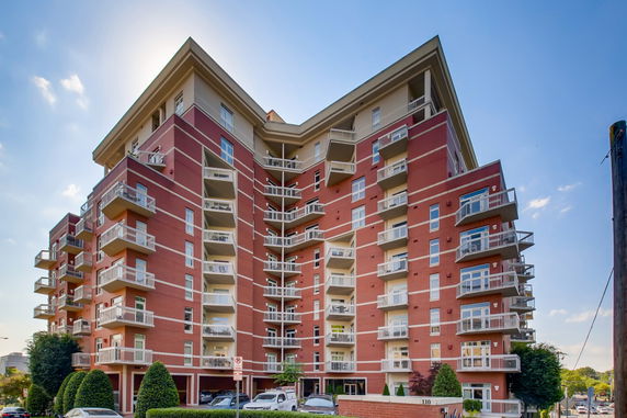 Front view of a multi-story residential building with balconies.