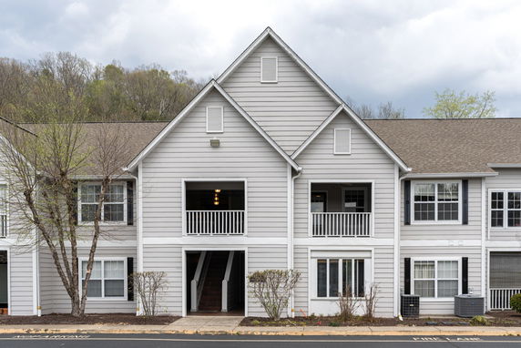 Front view of a two-story residential building with a central entrance.