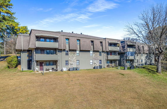 Front view of a multi-story building with balconies and stone accents.