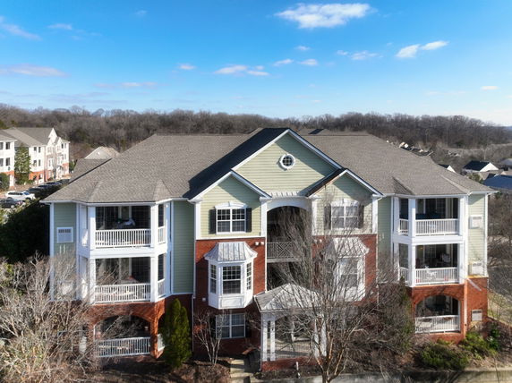 Front view of a multi-story apartment building with balconies.