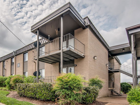 Front view of a two-story apartment building with balconies.