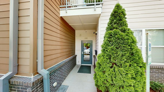 Entrance view of a building with a glass door and overhang.