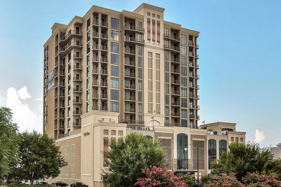 Front view of a multi-story residential building with balconies