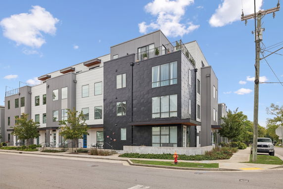 Front view of a modern multi-story building with a black and white facade.