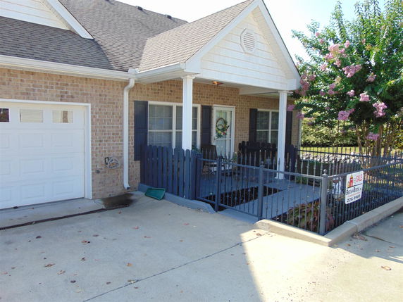 Front view of a house with a garage and small porch.