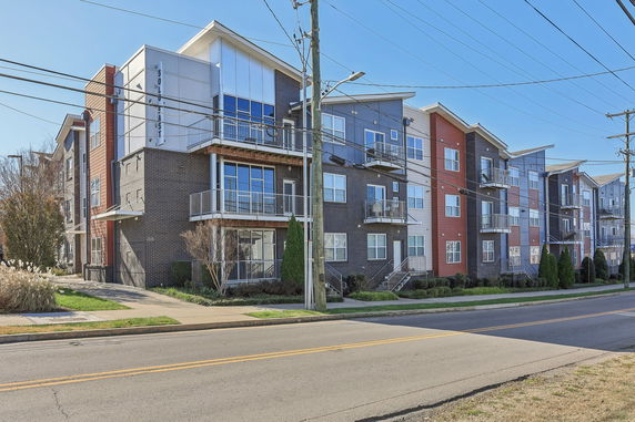 Front view of a multi-story apartment building with balconies.