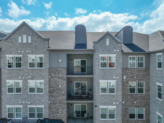 Front view of a multi-story residential building with balconies