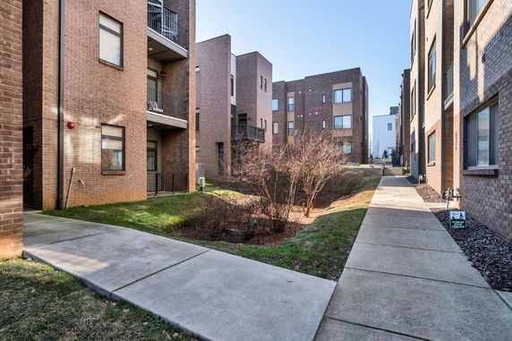 Brick apartment buildings with balconies and walkways.
