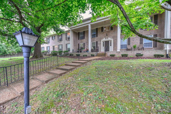 Front view of a two-story residential building with columns.
