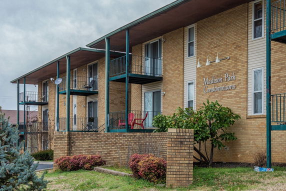 Front view of a two-story condominium building with balconies.