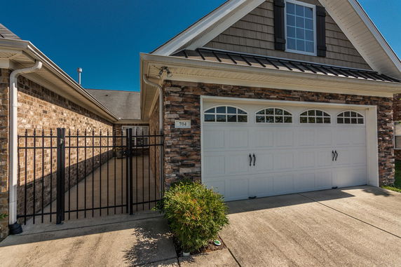 Front view of a house with a double garage and a stone exterior.