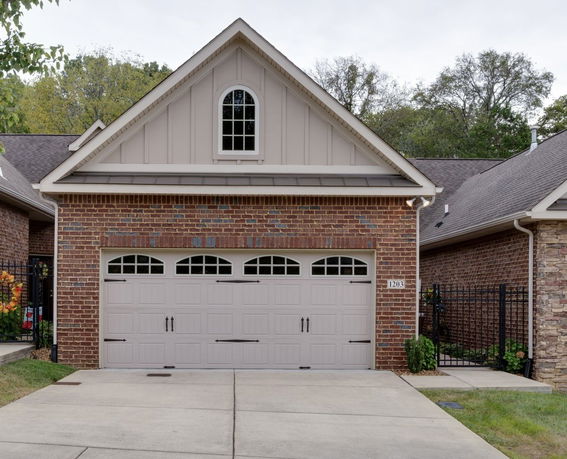 Front view of a brick house with a two-car garage.