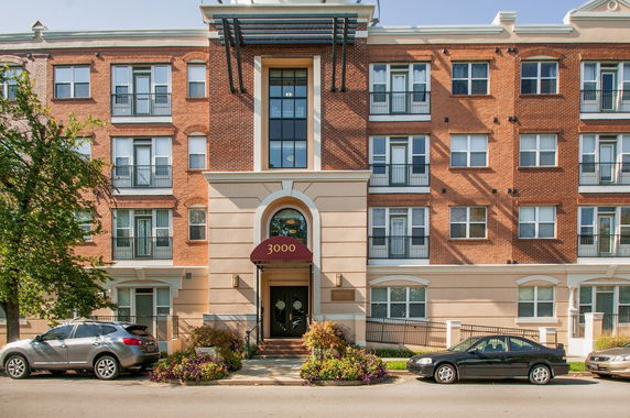 Front view of a multi-story residential building with a central entrance.