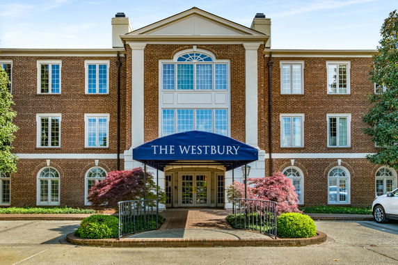 Front view of a brick building with a blue canopy entrance labeled 'The Westbury'.