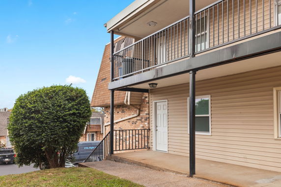 Front view of a two-story apartment building with a balcony.