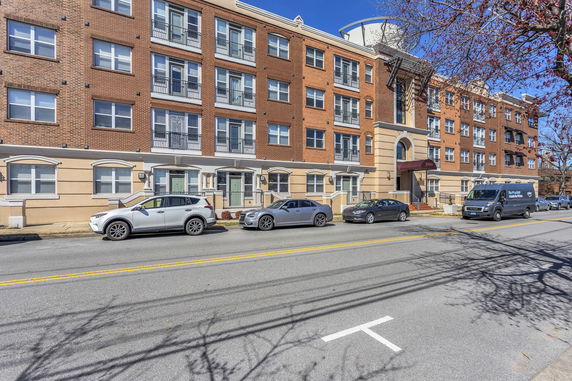 Front view of a multi-story residential building with a brick facade.