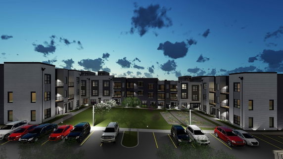 Front view of a multi-story residential building with a parking area.