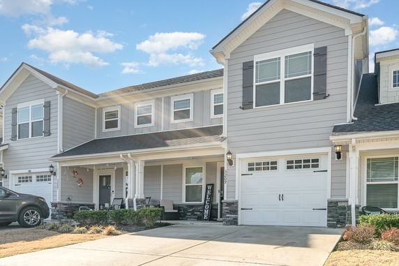 Front view of a two-story house with a garage.