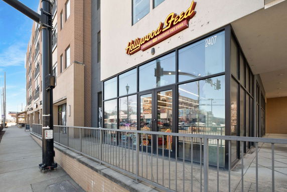 Front view of a commercial building with large glass windows and a sign above the entrance.