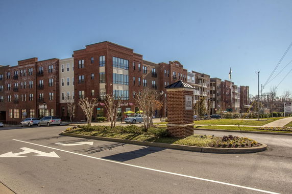 Front view of a multi-story apartment building with brick facade.
