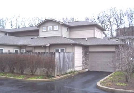Front view of a two-story house with an attached garage.
