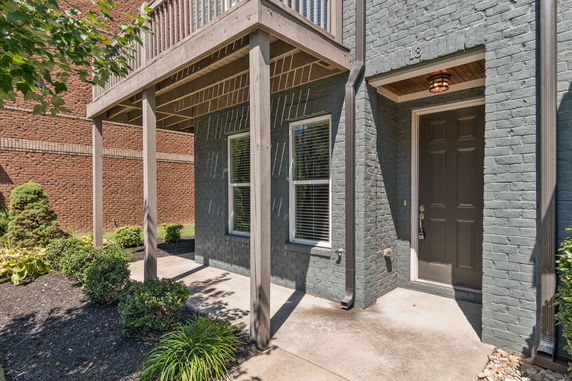 Front view of a house with brick exterior and covered entrance.
