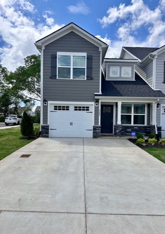 Front view of a two-story house with a single garage.