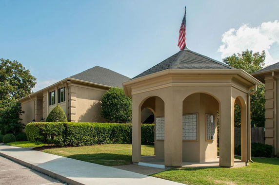 Front view of a building with a gazebo structure in the foreground.