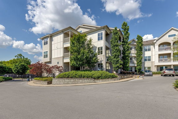 Front view of a multi-story residential building with balconies.