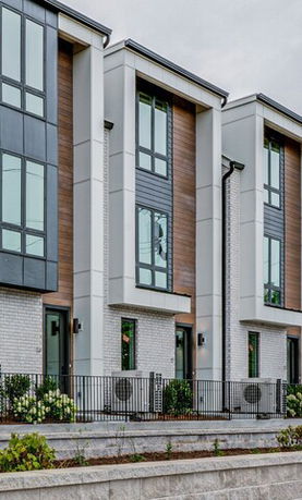 Front view of a modern multi-story townhouse with a contemporary facade.