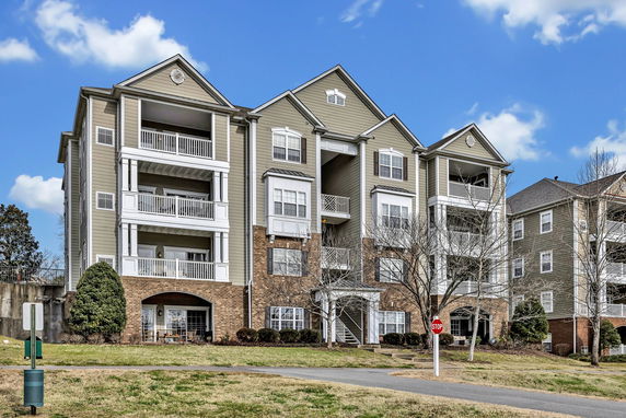 Front view of a multi-story residential building with balconies.