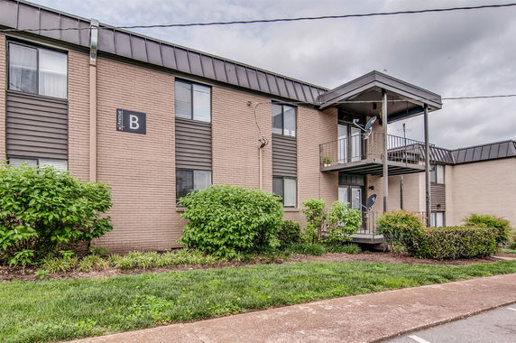 Front view of a two-story apartment building with a small balcony.