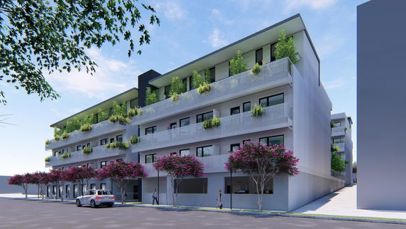 Front view of a modern multi-story building with greenery on each balcony.