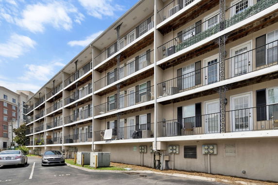 Front view of a multi-story residential building with balconies.