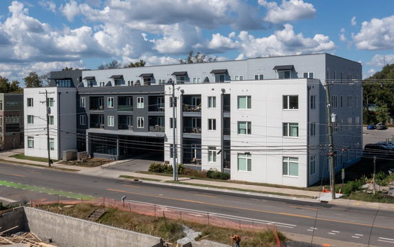 Front view of a multi-story residential building with balconies.