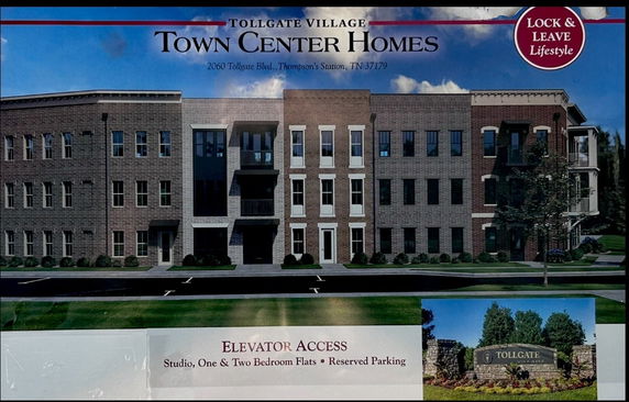 Front view of a multi-story residential building with brick facade.