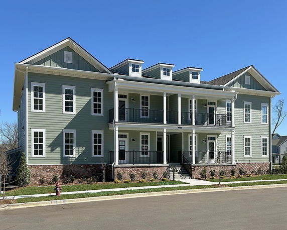 Front view of a two-story house with balconies.