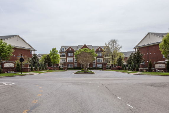 Front view of a multi-story brick residential building complex.