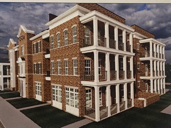 Front view of a multi-story brick building with multiple balconies.