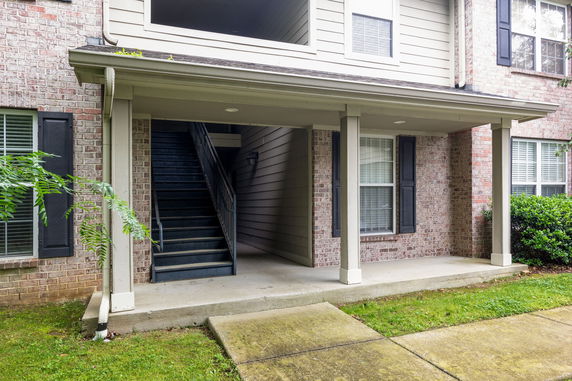 Front view of a building entrance with stairs leading to the upper level.