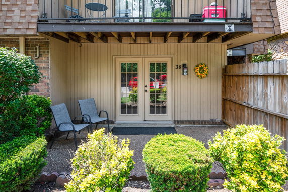 Front view of a house with a patio and balcony.