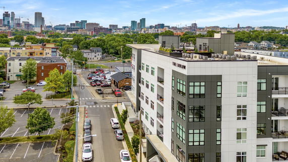 Panoramic view of a cityscape with a building and surrounding area.